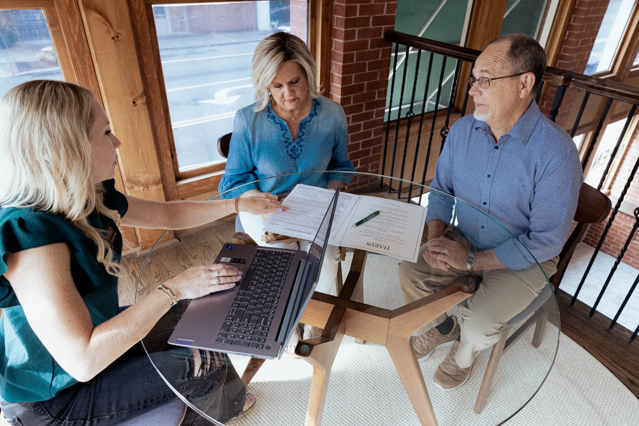 Hardy Realty agent consulting with clients at Hardy on Main